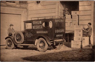 an old photo of a delivery truck parked in front of a building