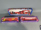two toy trucks that are sitting next to each other
