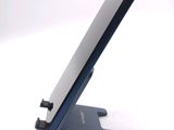 a cell phone sitting on a stand on a white surface