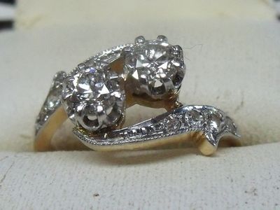 an image of a close up of a diamond ring on a white cloth