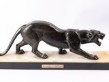 an image of a statue of a black panther on a marble base