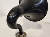 a black hornphone sitting on top of a table next to a pair of scissors