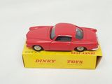 a red toy car sitting on top of a yellow box