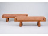 a pair of wooden benches with orange upholstered cushions