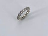 a close up of a diamond ring on a white surface