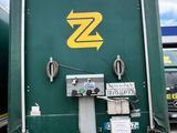 a large green truck with a yellow z on the side