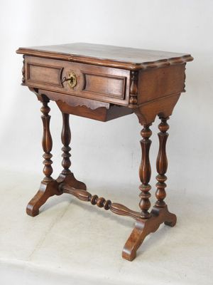 an old wooden table with a drawer on top of it