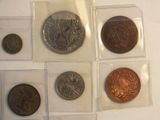 several different types of coins are displayed on a white surface