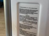 a white refrigerator with a yellow sticker on it
