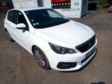 la photo d'une voiture blanche garée devant un bâtiment