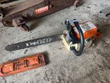 a chainsaw and a tool on the floor next to a tool box