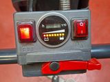 a close up of a clock on the handlebar of a bike