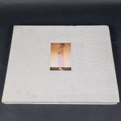 a white album with a picture of a woman in a white dress