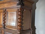 a large wooden cabinet with a mirror on top of it