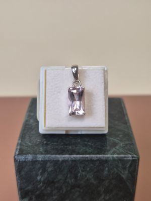 sterling silver pendant with a pink topazn stone in a box