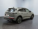 the rear view of a grey suv parked in a room