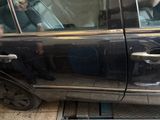 a man sitting in a car with a cell phone in his hand