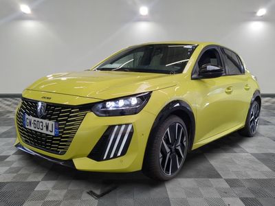 a yellow car parked in a garage with a checkered floor