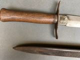 two knives that are laying next to each other on a table
