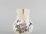 an image of a white vase with blue and pink flowers on it