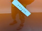 a man holding a sign that says varo