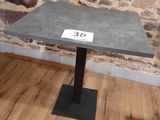 a small table with a number on it in front of a stone wall
