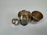 three cups and a spoon sitting on a table