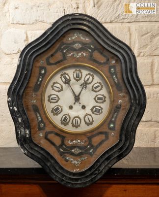 a clock that is sitting on a table in front of a brick wall
