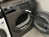 two washers and a dryer in a small room
