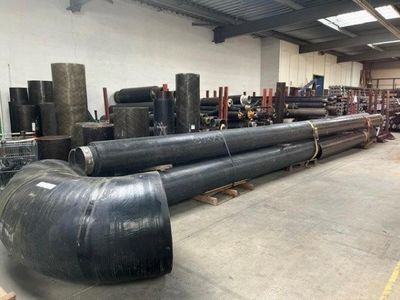 a lot of pipes that are sitting in a warehouse