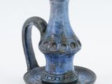 a small blue vase with a saucer on a saucer