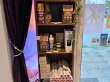 a shelf with various items on it in front of a window
