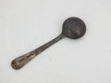 a spoon and a spoon rest on a white surface