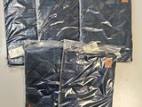 four pairs of men ' s jeans in plastic bags on a white surface