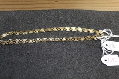 a close up of a gold chain with a price tag on it