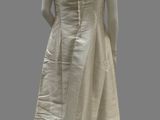 an image of a mannequin wearing a white dress with ruffles on it