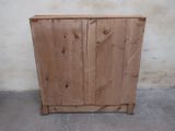 a wooden cabinet that is sitting in the corner of a room