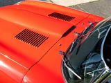 a close up of a red car with its hood open