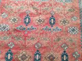 a red and blue rug with a pattern on it
