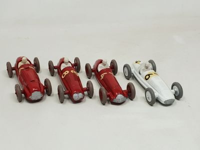several toy cars are lined up in a row on a white surface