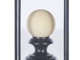 an image of a glass display case with a white ball inside of it