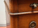 a wooden chest of drawers with metal handles and knobs