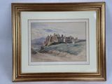 un tableau représentant un château sur une colline, dans un cadre doré