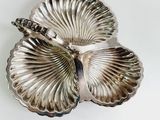 a silver plate that has a butterfly on it