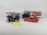 two toy cars and a remote control car in a box