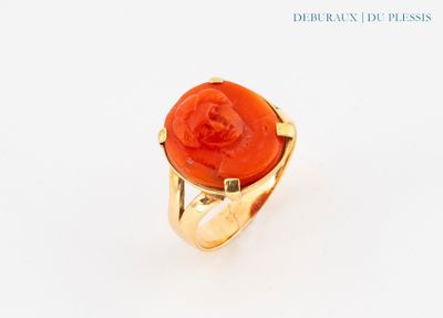 an image of a gold ring with a red stone in the center