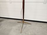 a lamp that is on a stand in front of a garage door