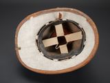 a hat with a cross on it sitting on a table