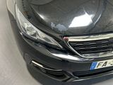 a black car that is parked in a showroom
