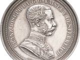 an image of a silver coin with a portrait of a man on it
